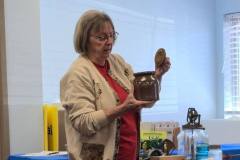 Judy LaMay shows off a bean crock